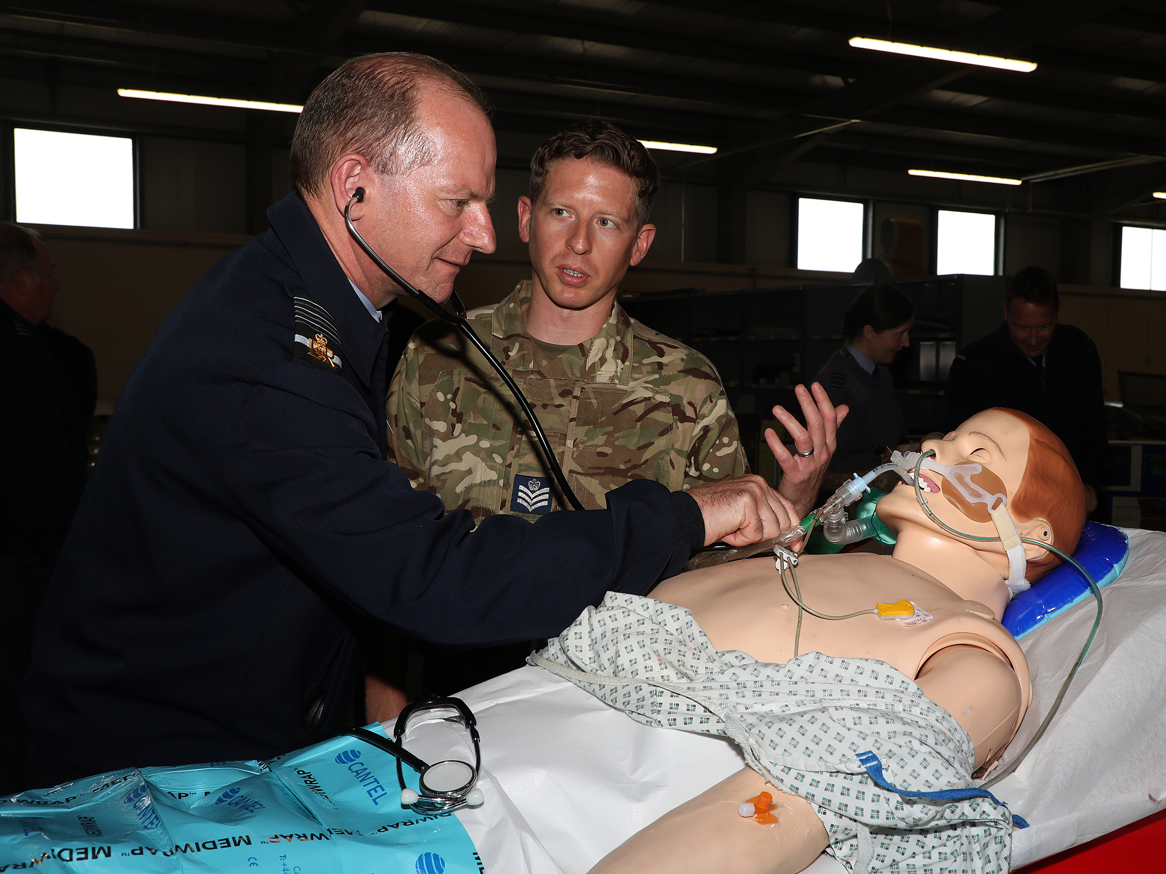 Sir Mike is given a demonstration of the SimMan training aid by Tactical Medical Wing